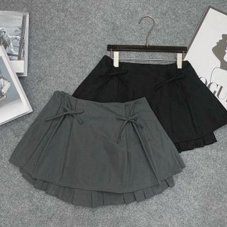 CHÂN VÁY NGẮN XẾP LY ĐÍNH NƠ - NHƯ Ý BOUTIQUE