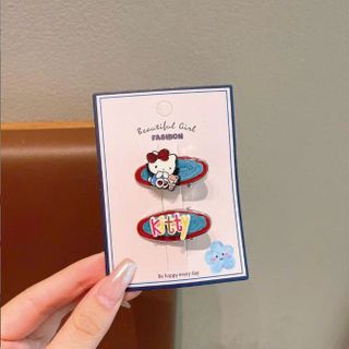 VĨ 2 KẸP TÓC KITTY NỀN XANH DƯƠNG