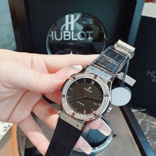 ĐỒNG HỒ COUPLE SIÊU CẤP NHÀ MÁY HB HULOT CAO SU BỌC DA ĐEN CÓ GIẤY KIỂM ĐỊNH