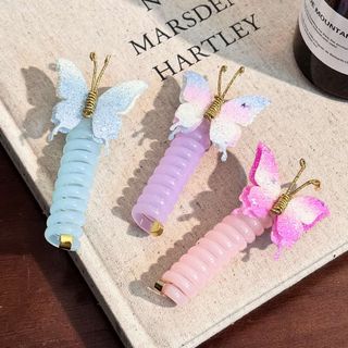 Kẹp tóc bướm xoắn pastel lấp lánh