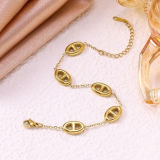 Vòng tay nữ thép titan mắt oval tone vàng sang trọng Vòng Tay Thép Titan Mũi Lợn
